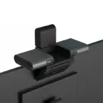 K100 AI voice webcam mounted on a monitor back view showing USB Type-C power input and 3.5mm audio jack
